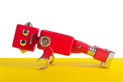 Red colored robot doing push ups. Stock Photos