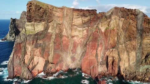Red coloured volcanic cliffs and stacks at Ponta do Rosto, Madeira Stock Footage 311894403