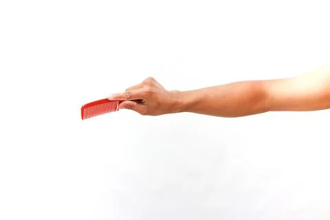 Red Comb Held by Hand Ready to Groom, Isolated on White Backdrop Studio Stock Photos