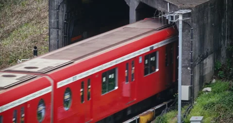 Red Commuter Train Exiting Concrete Tunnel Portal Side View Tokyo 스톡 동영상 344534737