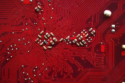 Red computer motherboard chip close-up with elements 스톡 사진