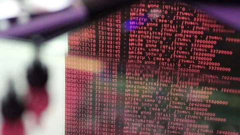 Red computer software code moving on a black monitor reflect on glass. Abstra 스톡 동영상 144047610