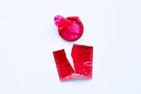 Red condom on white Foto stock