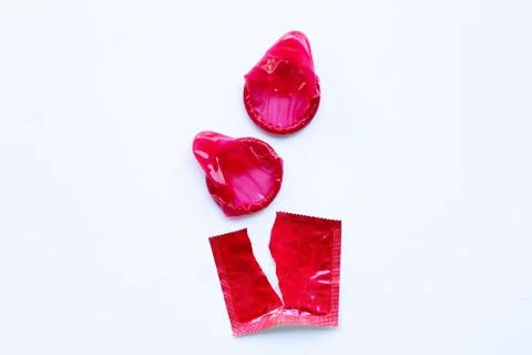 Red condom on white Stock Photos