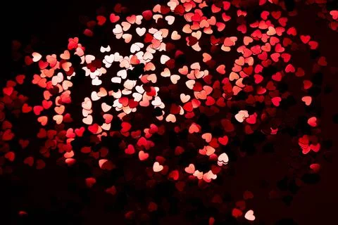 Red confetti on a black background Stock Photos