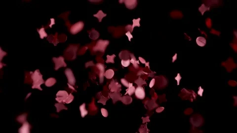 Red confetti falling in slow motion into black abyss, studio shot. Stock Footage 146894453