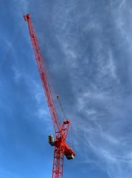 Red construction crane over blue sky 스톡 사진