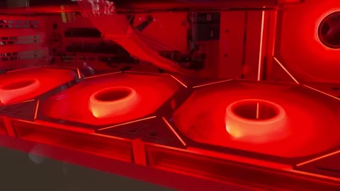 Red cooling fans lighting up inside custom pc case Stock Footage 307927192