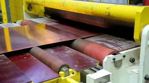 Red copper sheet tape is fed into the machine Stock Footage 103848149