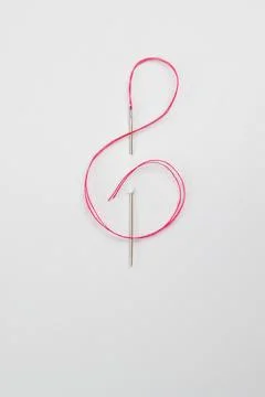 Red cord through the Needle In The Form Of A Treble Clef Stock Photos