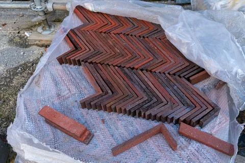 Red corner bricks arranged in zigzag pattern for construction project Stock Photos