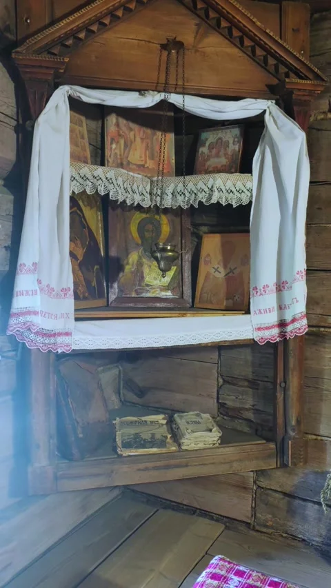 Red corner in a peasant hut. A holy corner with icons in a peasant house. Stock Footage 289520047