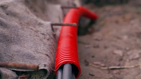 Red corrugated pipe for protecting electrical wiring, close-up Stock Footage 310558766