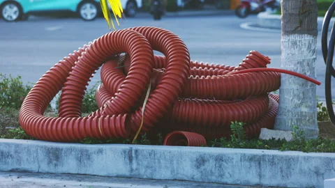 Red corrugated plastic pipe at construction site Stock Footage 338343270