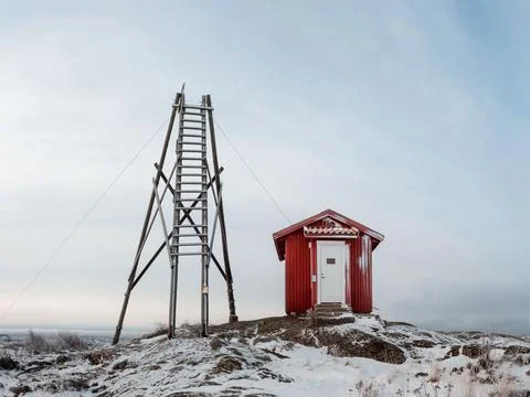 Red cottage on top of a snowy mountain Stock Photos