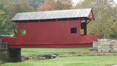 Red covered bridge in a town park 스톡 동영상 141765249