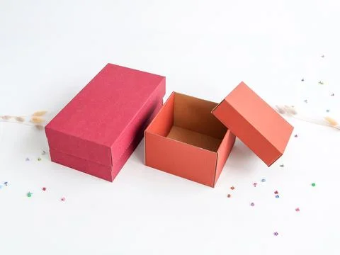 Red craft boxes of different sizes on a white background. The concept of gi.. Stock Photos