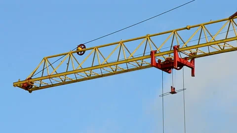Red crane beam on the blue sky, cargo object, construction site. Stock Footage 89853423