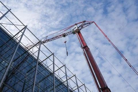 A red crane by a building Stock Photos