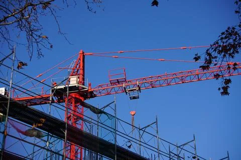 Red crane working in construction site. Stock Photos