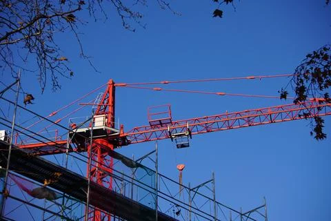 Red crane working in construction site. Stock Photos