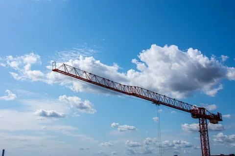 Red crane working to create new building Stock Photos