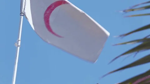 Red Crescent flag waves above the infirmary in Amerli, Iraq Stock Footage 120363384