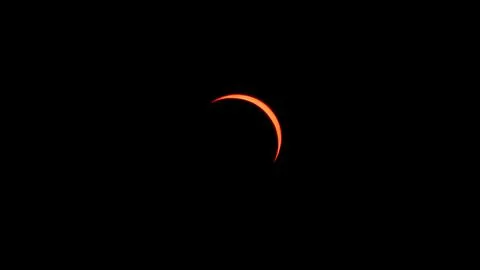 Red crescent Sun during partial solar eclipse in Saint-Étienne Stock Photos