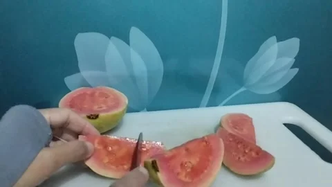 Red crystal guava fruit cut into small triangular shapes Stock Footage 229253190