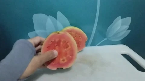 Red crystal guava fruit which is split into two Stock Footage 229252722