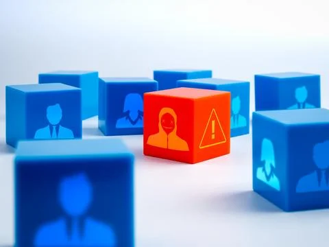 Red cube with scammer icon hidden among blue user blocks, symbolizing cyber.. Stock Photos