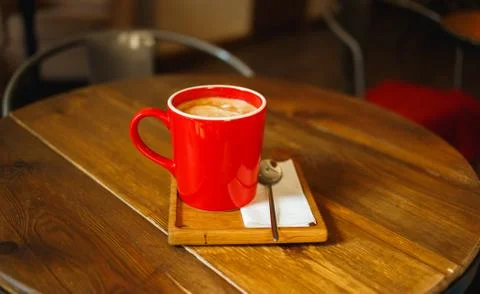 Red cup of coffee in a cafe on table. Place for rest Stock Photos