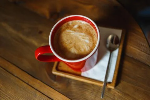 Red cup of coffee in a cafe on table. Place for rest Stock Photos