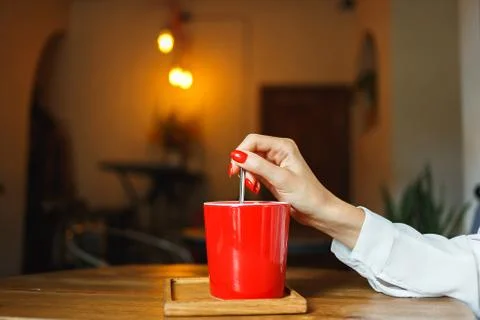 Red cup of coffee in a cafe on table. Place for rest Stock Photos