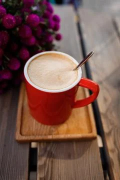 Red cup of coffee in a cafe on table Stock Photos