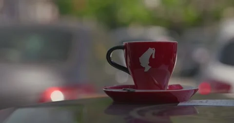 Red cup of coffee on saucer on table 스톡 동영상 332512590