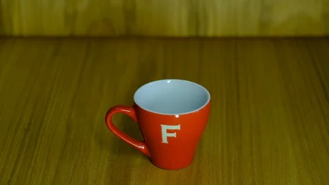 Red cup for coffee on the table Video stock 129768260