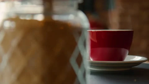 Red cup of steaming hot coffee on table in cafe Stock Footage 168910703