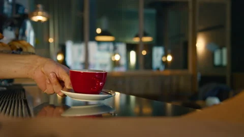Red cup of steaming hot coffee on table in cafe Video stock 230930014