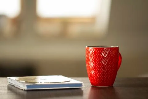 Red cup on table in soft light Stock Photos