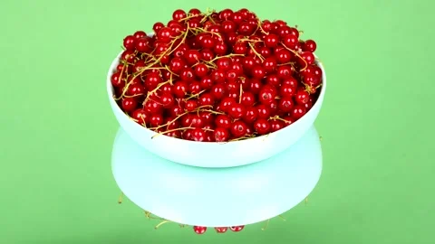 Red currant on green mirror. Side view. Loop motion. Rotation 360. Stock Footage 160244065
