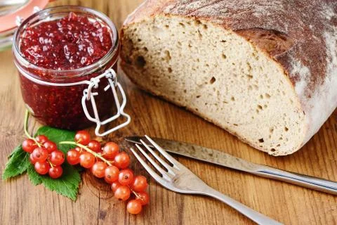 Red currant jam and fresh bread Stock Photos