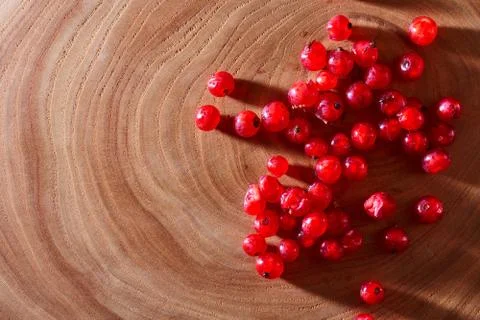 Red currants on wooden background. With copy space. Close-up. Top view. Stock Photos