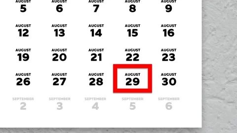 Red cursor highlighting August 29th on a 2026 wall calendar page Stock Footage 340558157