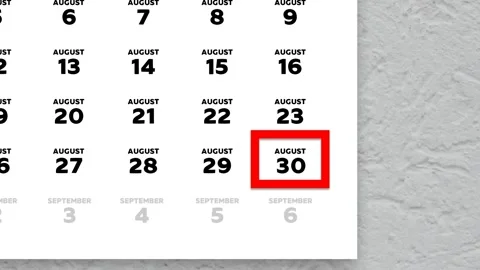 Red cursor highlighting August 30th on a 2026 wall calendar page Stock Footage 340558807
