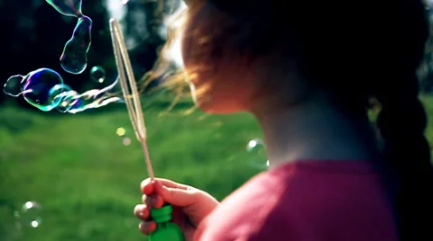 The red cute girl blows the soapbubbles 2 Stock Footage 38832496