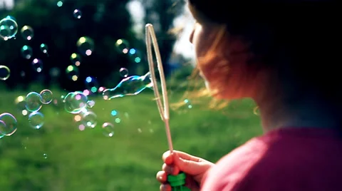 The red cute girl blows the soapbubbles Stock Footage 38832498