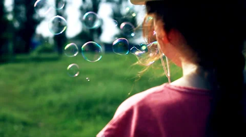 The red cute girl blows the soapbubbles 3 Stock Footage 38832499