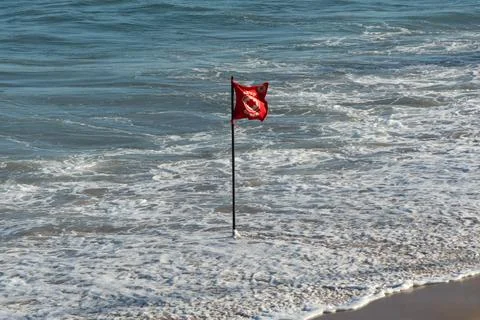 Red danger flag on the beach Stock Photos