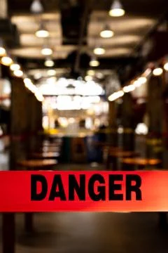 Red danger tape blocking off empty public seating area during Covid-19 outbreak Stock Photos